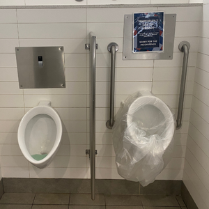 Urinal covered with an improvised garbage bag